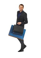 Image showing handsome man in suit with shopping bags