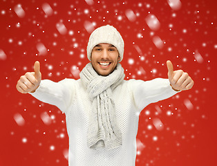 Image showing handsome man in warm sweater with snow