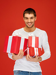 Image showing man holding many gift boxes