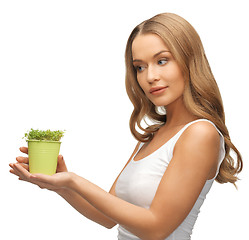 Image showing woman with green grass in pot