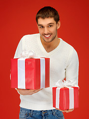 Image showing man holding many gift boxes