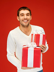 Image showing man holding many gift boxes