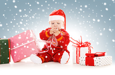 Image showing santa helper baby with christmas gifts