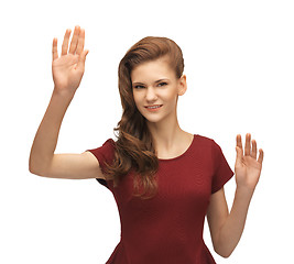 Image showing girl in red dress working with something imaginary