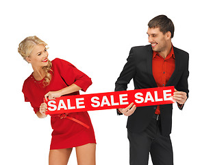 Image showing man and woman with sale sign