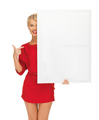 Image showing lovely woman in red dress with blank board