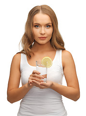 Image showing woman with lemon slice on glass of water