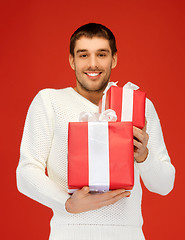 Image showing man holding many gift boxes