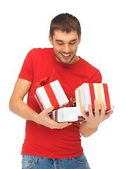 Image showing man holding many gift boxes