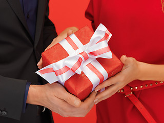 Image showing man and woman's hands with gift box