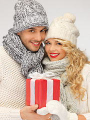 Image showing romantic couple in a sweaters with gift box