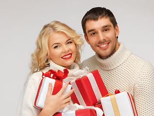 Image showing family couple in a sweaters with gift boxes