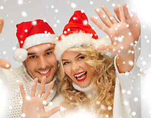 Image showing family couple in sweaters and santa's hats