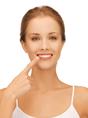 Image showing beautiful woman pointing to teeth