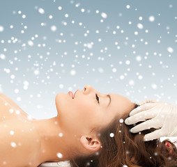 Image showing beautiful woman in massage salon with snow