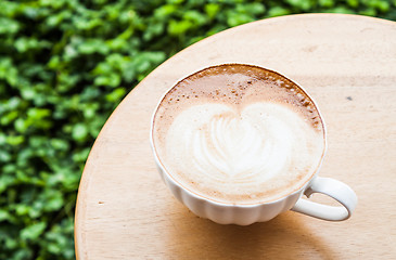 Image showing Free pour hot coffee latte serving on wood table