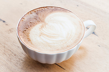 Image showing Free pour hot coffee latte art cup on wood background