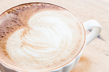 Image showing Free pour hot coffee latte art cup up close