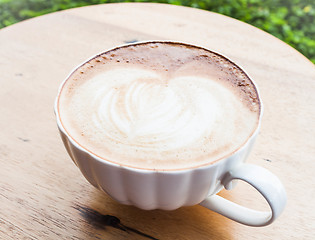 Image showing Free pour hot coffee latte cup serving in garden