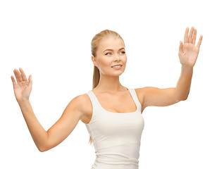 Image showing woman in white t-shirt pressing imaginary button