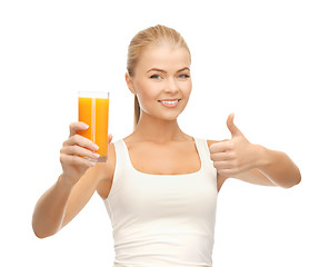 Image showing woman holding glass of orange juice