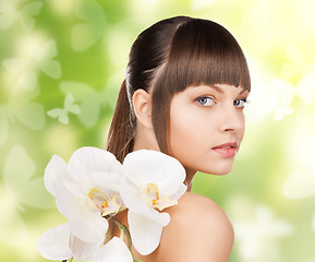 Image showing beautiful woman with orchid flower and butterflies