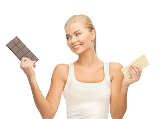 Image showing smiling woman with dark and white chocolates