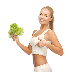 Image showing sporty woman with lettuce showing abs