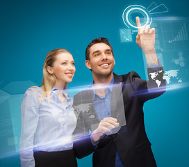 Image showing man and woman working with virtual touch screens