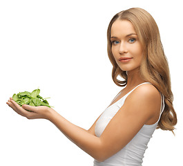 Image showing woman with spinach leaves on palms