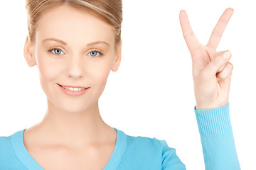 Image showing young woman showing victory or peace sign