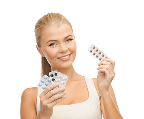 Image showing young woman with pills