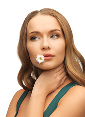 Image showing woman with camomile in mouth