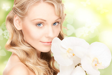 Image showing beautiful woman with orchid flower and butterflies