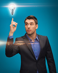 Image showing man in suit with light bulb