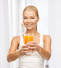 Image showing woman holding glass of orange juice