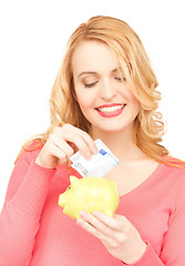 Image showing woman with piggy bank and cash money