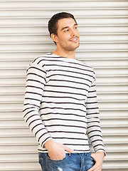 Image showing handsome man in casual clothes leaning to wall