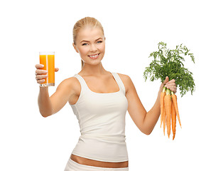 Image showing woman holding glass of juice and carrots