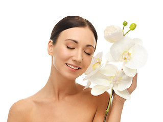 Image showing smiling woman with white orchid flower