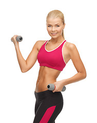 Image showing young sporty woman with light dumbbells