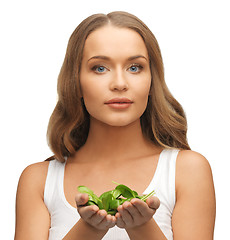 Image showing woman with spinach leaves on palms