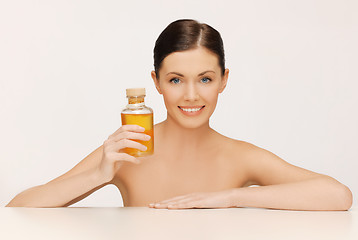 Image showing woman with oil bottle