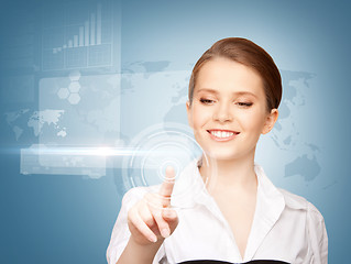 Image showing businesswoman touching virtual screen