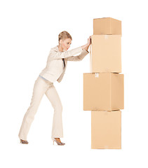 Image showing businesswoman moving big boxes