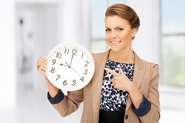 Image showing woman holding big clock