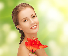 Image showing lovely woman with red lily flower