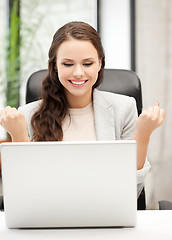 Image showing smiling businesswoman celebrating victory or win