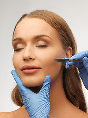 Image showing woman face and beautician hands