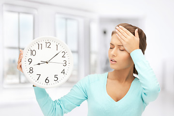 Image showing woman holding big clock